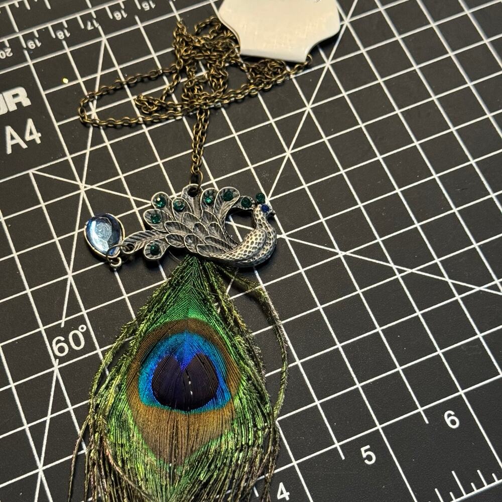 Silver tone peacock with feather and rhinestones colorful